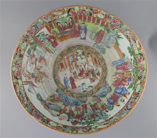 A large Chinese Canton-decorated famille rose punch bowl, c.1830, W.41.5cm, section broken and restuck, and two hairline cracks